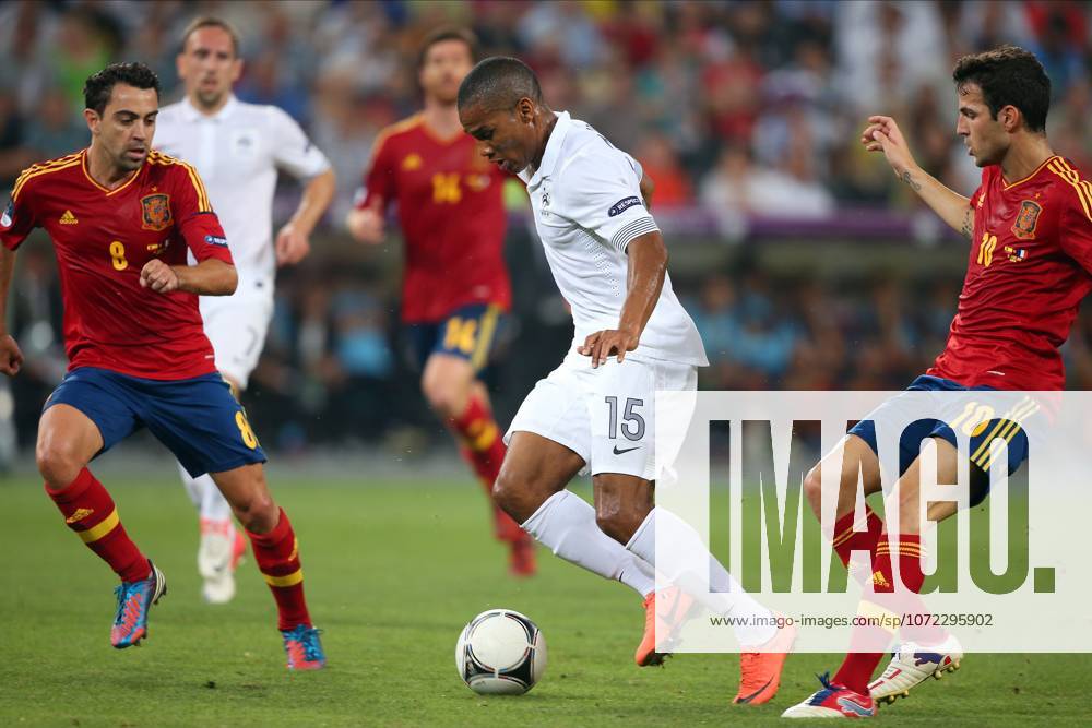 Spain V France, UEFA EURO, EM, Europameisterschaft,Fussball 2012 Quarter Final Xavi Hernandez of Spain, Florent Malouda of France and Cesc Fabregas of Spain challenge during the UEFA Euro 2012 Quarter Final match between Spain and France at Donbass Arena on June 23, 2012 in Donetsk, Ukraine. Donetsk Donbass Arena Ukraine Ukraine