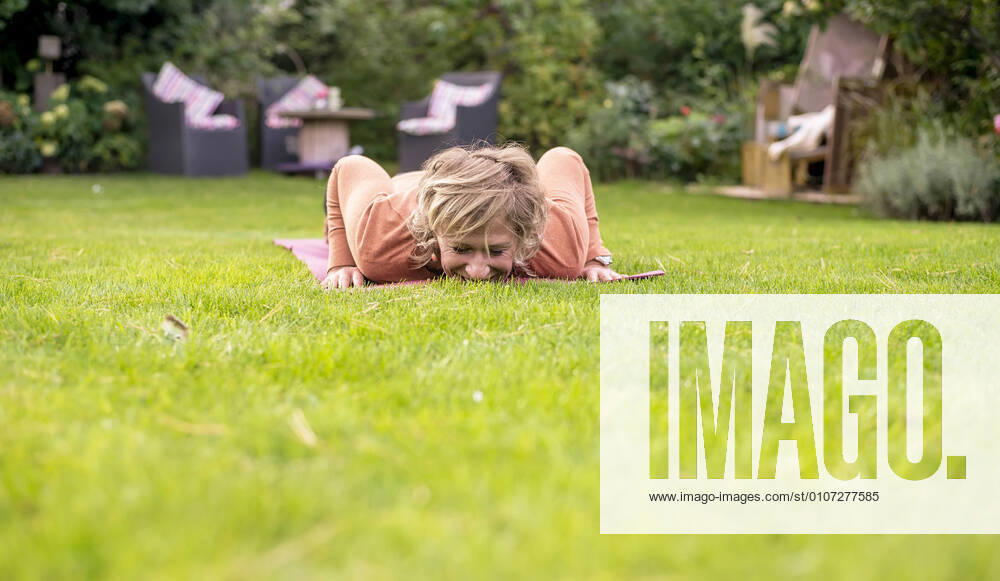 Woman doing push-ups in the garden