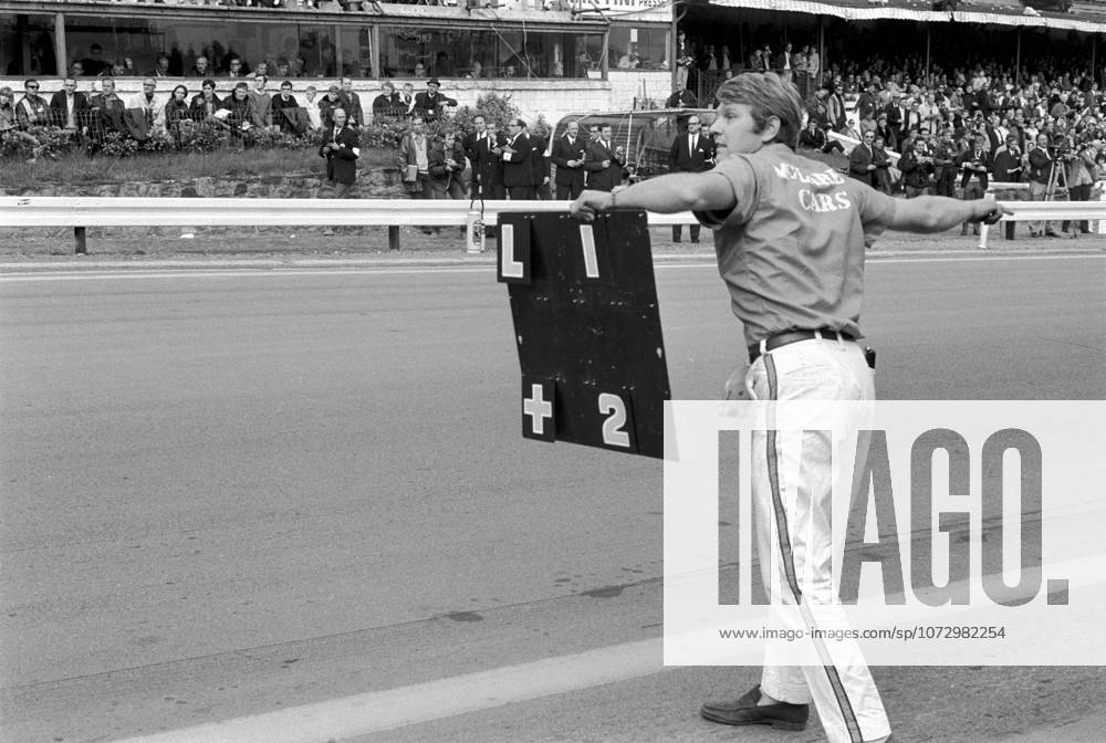 McLaren s Tyler Alexander attempts to instruct Bruce McLaren (NZL) McLaren M7A that Jackie Stewart (GBR) had stopped - out of fuel - within sight of the finish, handing Bruce his first victory for six years and the first GP win for the McLaren team. ..Belgian Grand Prix, Spa-Francorchamps, June 9 1968.