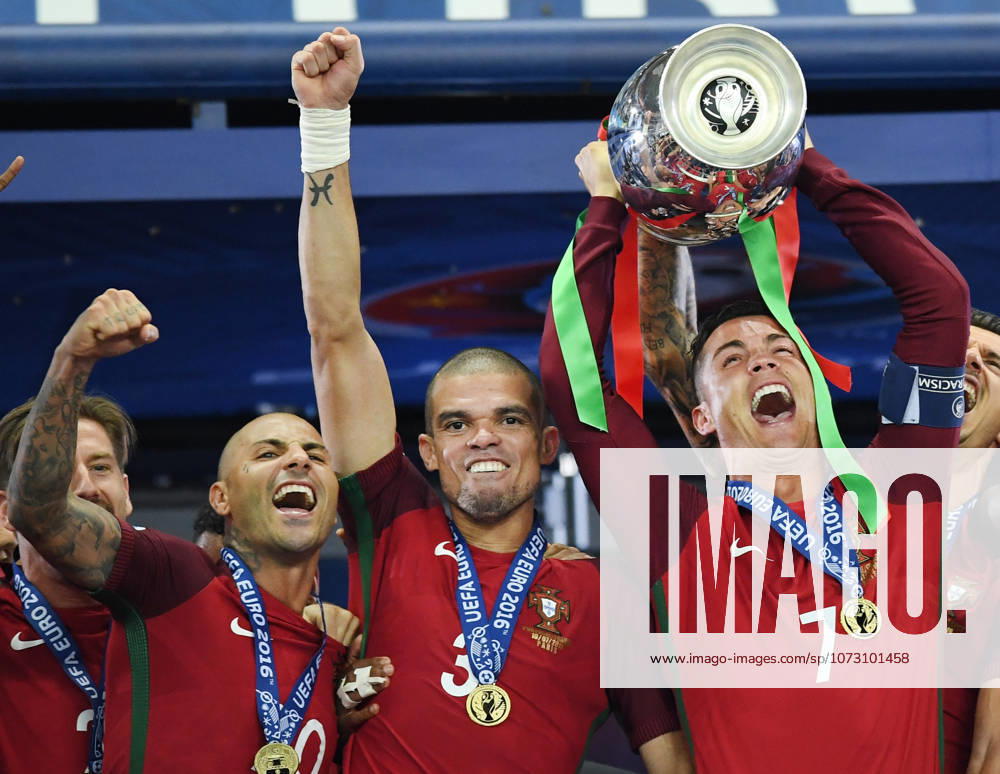 Portugal wins UEFA EURO, EM, Europameisterschaft,Fussball 2016 PARIS, FRANCE - JULY 10: Portugal s forward Cristiano Ronaldo hold up the winners trophy as he celebrates with teammates Portugal s forward Ricardo Quaresma (L), Portugal s defender Pepe (C) after beating France 1-0 to clinch the Euro 2016 final football match between France and Portugal at the Stade de France in Saint-Denis, north of Paris, on July 10, 2016. Ile-de-France France. Editorial use only. Please get in touch for any other usage.