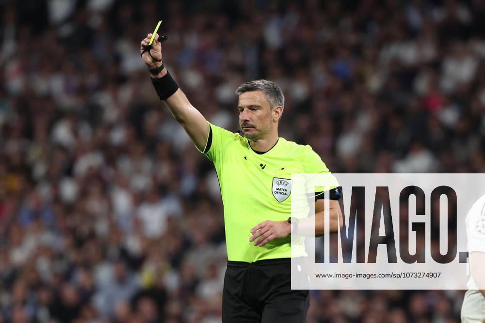 Madrid, Spain February 25, 2026 FBL UEFA Champions League 2025 26 Real Madrid SL Benfica referee Slavko Vincic SVN shows a yellow card during the UEFA Champions League 2025 26 knockout play offs match between Real Madrid and SL Benfica at the Santiago Bernabà u Stadium on February 25, 2026 in Madrid, Spain