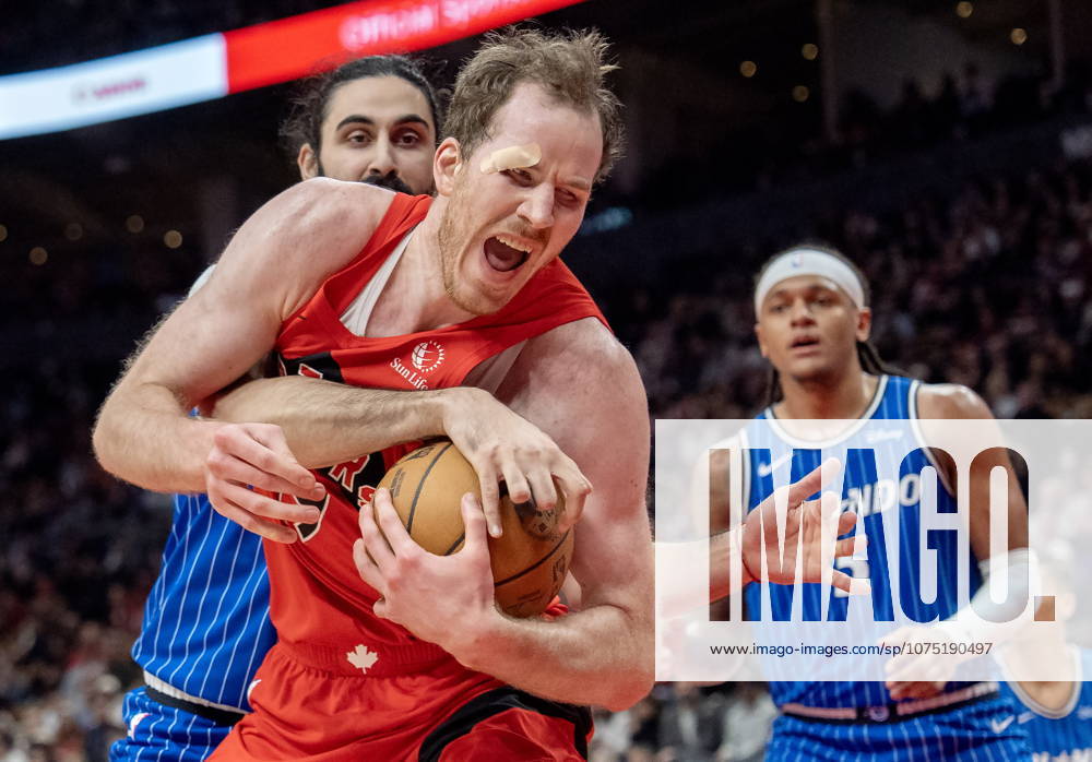 Toronto Raptors centre Jakob Poeltl (front) is fouled by Orlando Magic centre Goga Bitadze (back left) as Magic forward Paolo Banchero (right) looks on during first half NBA, Basketball Herren, USA action in Toronto on Sunday, March 29, 2026. Canada News - March 29, 2026 - ZUMAc35_ 20260329_zaf_c35_184