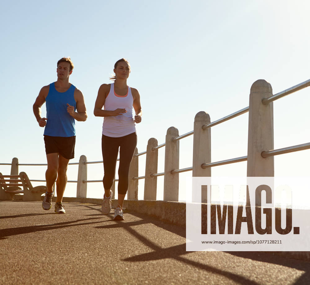 In it for the long run. a young couple jogging together the promenade (License=RF) 20136259 ,model released, Symbolfoto