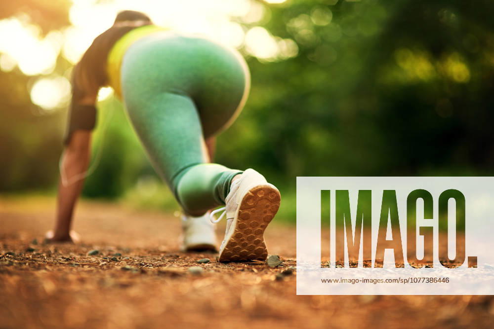 Fitness, woman and start running outdoor for body health, wellness and exercise in nature. Cardio, ready and athlete training at park to prepare for race, marathon and sprint for workout in rear view. (License=RF) 21871610 ,model released, Symbolfoto