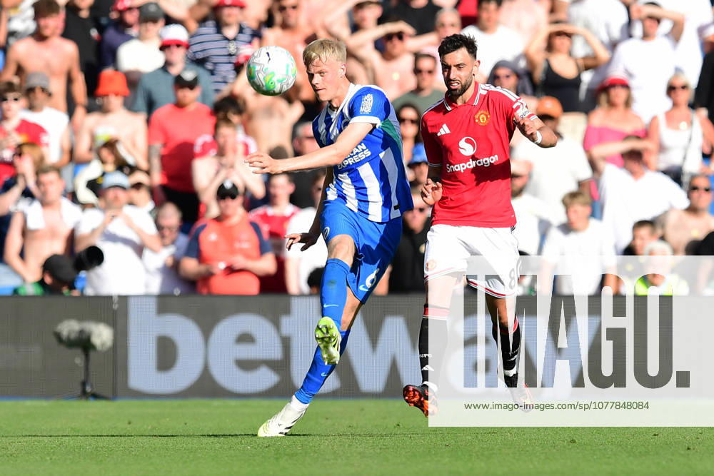 Brighton and Hove Albion v Manchester United, ManU Premier League Jan Paul van Hecke Defender of Brighton and Hove Albion plays the ball upfield under pressure from Bruno Fernandes Midfielder of Manchester United during the Premier League match between Brighton and Hove Albion and Manchester United at the American Express Stadium, Brighton and Hove, UK on 24 May 2026. Brighton and Hove American Express Stadium East Sussex UK Editorial use only DataCo restrictions apply See www.football-dataco.com ,