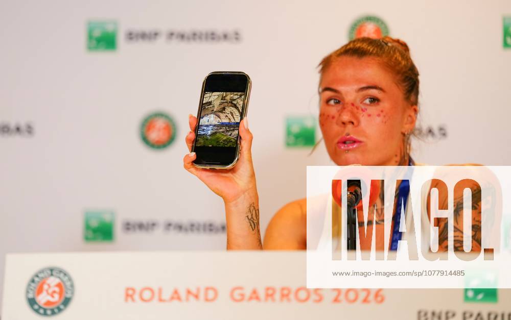 Following her first round win over Russian opponent Elena Pridankina, an emotional Oleksandra Oliynykova shows the gathered press a photograph of bombed out tennis courts in Ukraine, courts on which she used to play as a child French Open Tennis, Day Three, Tennis, Roland Garros, Paris, France - 26 May 2026Paris Roland Garros France