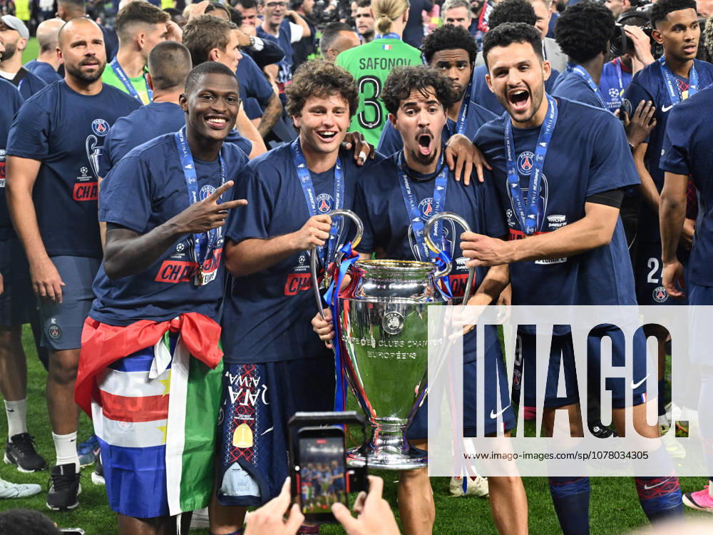 French players Nuno Mendes, Joao Neves, Vitinha and Goncalo Ramos pose next to the trophy after the Champions League final football match between Paris Saint Germain and Arsenal London during the Champions League final at the Ferenc Puskas Arena in Budapest, Saturday, May 30, 2026 Budapest