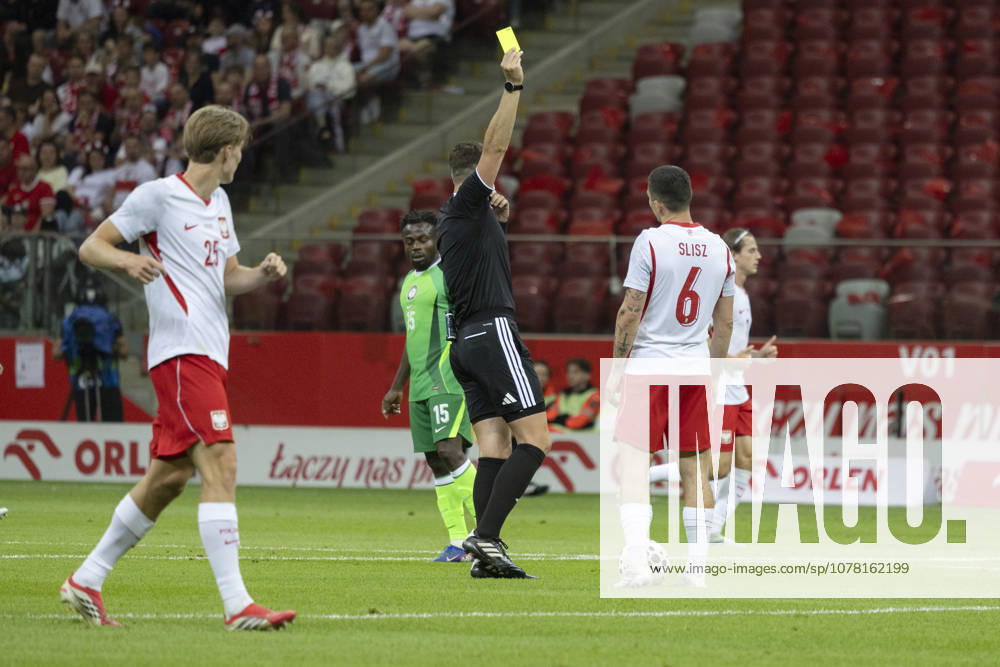 Poland - Nigeria 03.06.2026 football, Warsaw, PGE National Stadium, FIFA , friendly international game match Poland - Nigeria ( mecz towarzyski, pilka nozna, Polska - Nigeria ) image shows: referee Marian Barbu yellow card to Bartosz Slisz (R) photo Katarzyna Plewczynska Fotostyk