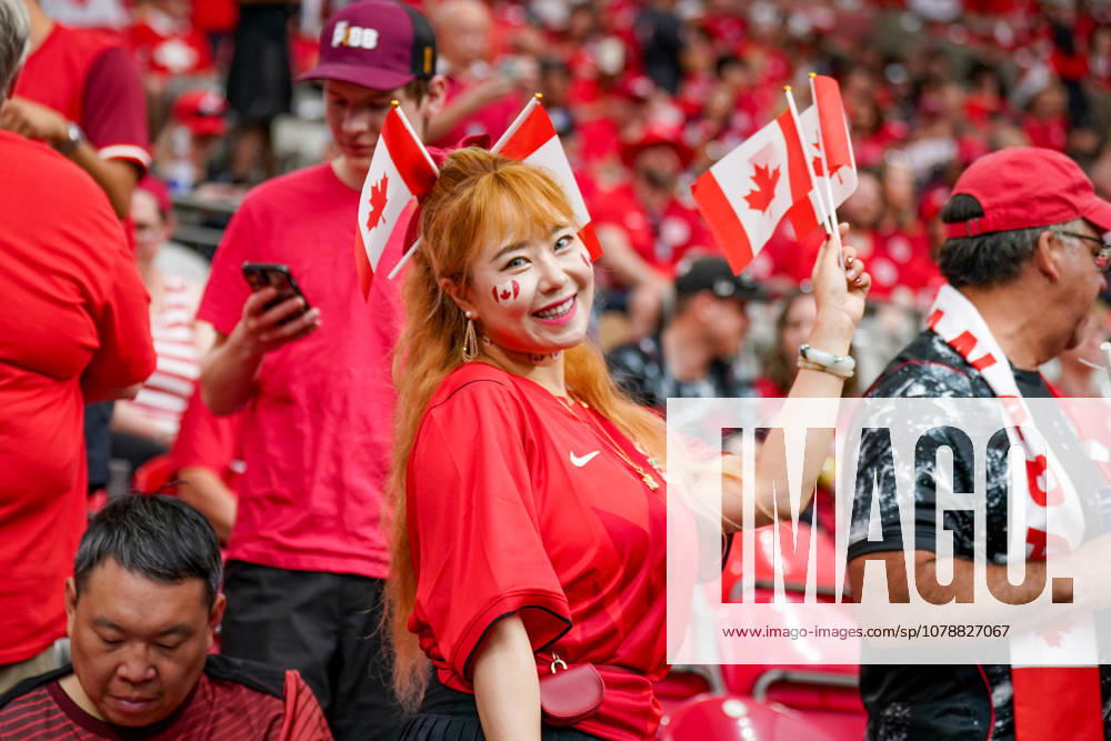 Canada Soccer 2026 FIFA World Cup Group Stage: Switzerland vs. Canada at BC Place Stadium in Vancouver, British Columbia; Canadian soccer fans, Fan portrait, female fan, Canadian flags, Canadian national flag, face paint, fan merchandise, fan culture, soccer enthusiasm, spectators, bleachers, stadium atmosphere, red and white clothing, supporters, fans, emotions, smiles, celebratory mood, public viewing atmosphere, sporting event, international audience, World Cup atmosphere, soccer fans, close-up, portrait, Canadian female supporter, fan section, sports, leisure, event, crowd