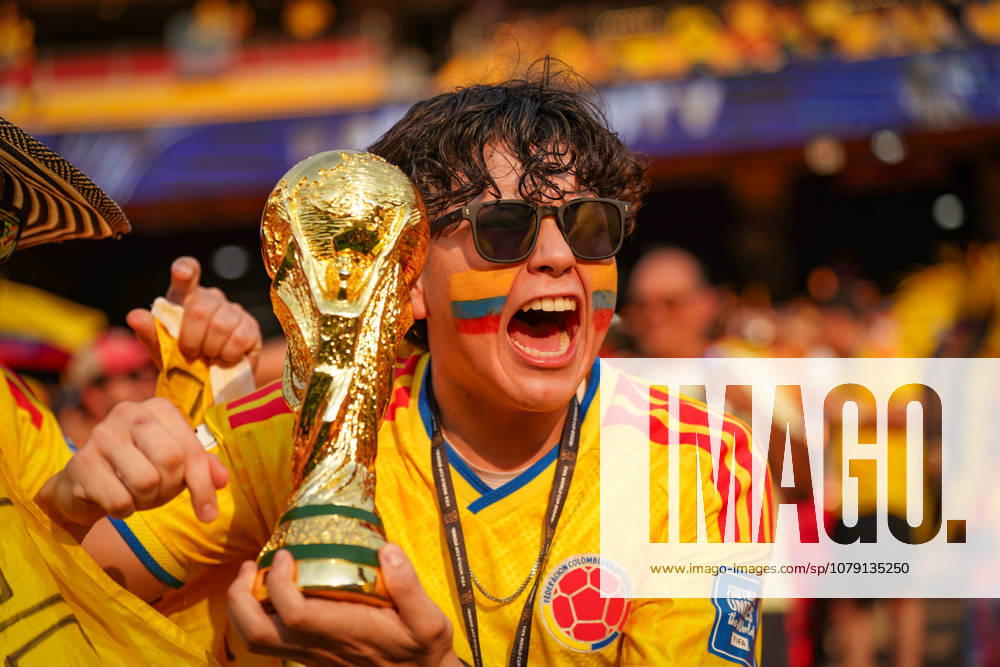 2026 FIFA World Cup in the U.S., K o Round of 32 Colombia vs. Ghana Kansas City Stadium Arrowhead Stadium An enthusiastic Colombian soccer fan wearing the national team’s jersey celebrates with a replica of the FIFA World Cup trophy. Face paint in the colors of Colombia, sunglasses, fans, fan culture, portrait, emotions, celebration, spectators, stands, stock image