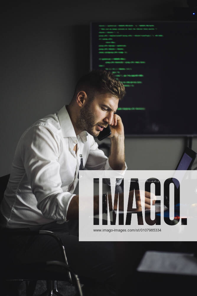 IT professional talking on smart phone while working in creative office, MA82904, Sweden, Stockholm, model released, property released