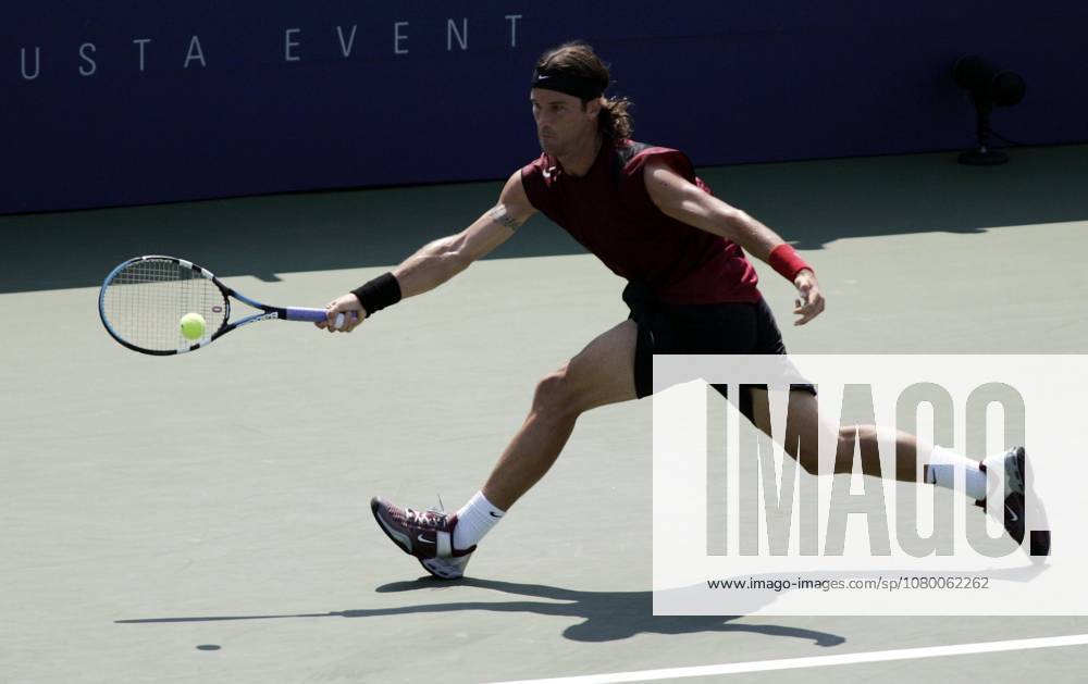 USA TENNIS US OPEN MOYA HITS RETURN TO ROCHUS epa000268944 Number three seed Carlos Moya of Spain chases down a forehand return to Olivier Rochus of Belgium during their third round match at the US Open in Flushing Meadows, New York, Saturday 04 September 2004. NEW YORK United States
