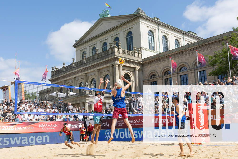 2026 German Beach Volleyball Championships: Manuel Harms of Kiel attacks against the block set by Valentin Schneckenburger of Munich. German Beach Volleyball Championships on July 24, 2026, in Hanover. Men’s quarterfinal match between 1 Beachclub Kiel and Beachvolley United Munich, Hanover, Lower Saxony, Germany, Opernplatz