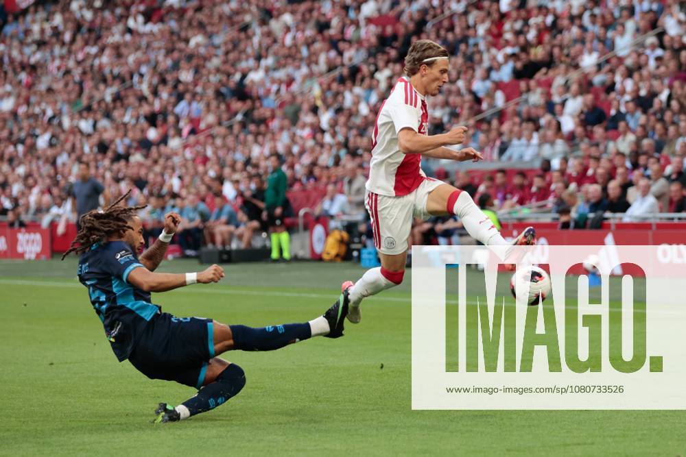 AMSTERDAM , 06-08-2026, Johan Cruijff ArenA , season 2026 2027 , UEFA Conference League play-off football . Match between Ajax and Shelbourne FC , Picture shows Shelbourne FC player Milan Mbeng, Ajax player Mika Godts Ajax - Shelbourne x205489017x
