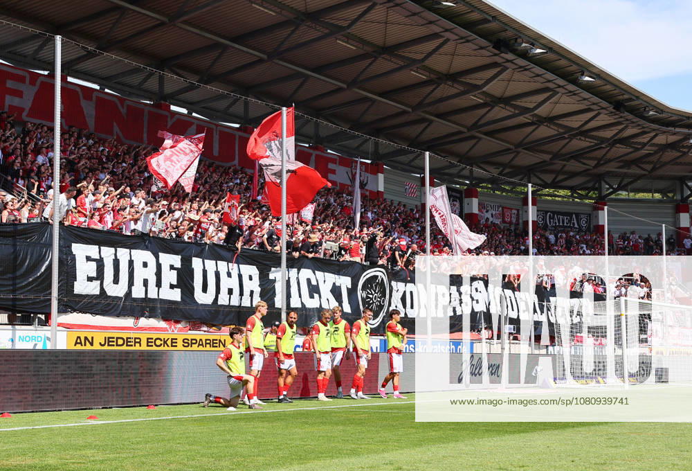 Hall S, August 9, 2026, Leuna Chemie Stadium, Regional League Northeast, Matchday 4, HALLESCHER FC vs. CHEMNITZER FC 0–0. Pictured: Hallescher FC fans chanting COMPASS MODEL NOW—YOUR CLOCK IS TICKING, Picture Point