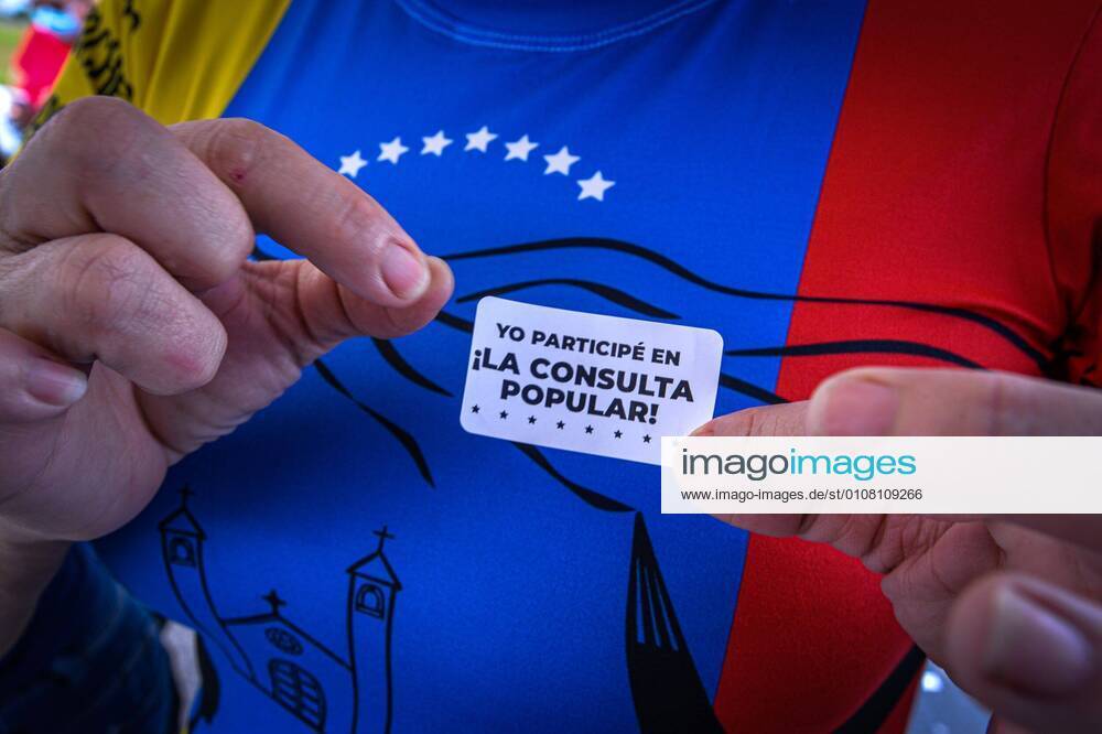 A Venezuelan citizen shows a sticker about his participation in the vote of the popular consultation promoted by the Venezuelan opposition leader Juan Guaido, from Doral Central Park, in Doral, Miami-Dade, Florida, United States, 12 December 2020. The community of Venezuelans living in Miami joined this Saturday in the face-to-face session of the popular consultation promoted by Guaido with which it seeks to measure the rejection of the last legislative elections, and whose results have been rejected by the United States Government. In the Miami metropolitan area, in southern Florida (USA), three of the 52 face-to-face points have been installed at the disposal of Venezuelans who want to participate in the consultation. Venezuelans in Miam