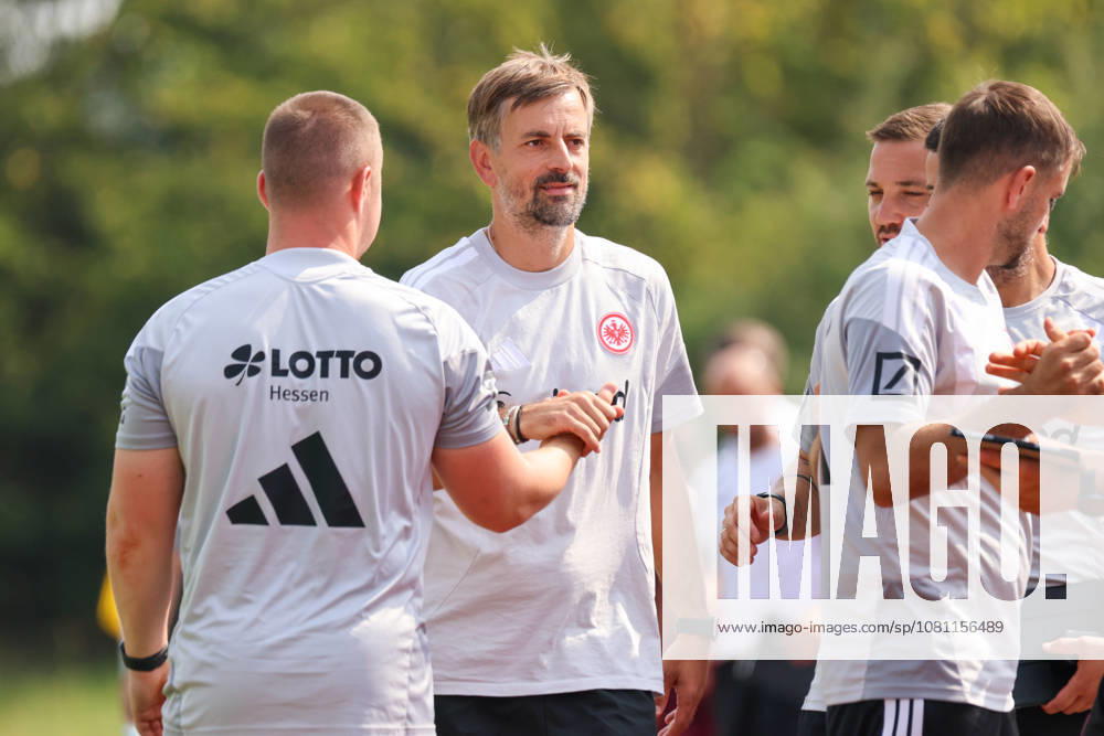 Herzogenaurach, Germany, August 16, 2026: Friendly match between Olympique Lyon Women and Eintracht Frankfurt Women. Pictured, from left, SGE assistant head coach Niko Arnautis high-fives his teammates after the victory over Lyon.