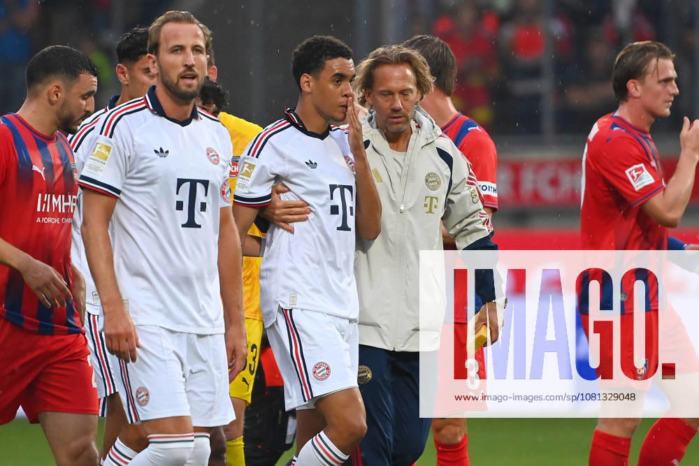 Jamal MUSIALA of Bayern Munich collapses again;faints, is led off the field by Dr. Peter UEBLACKER, FCB team doctor; featuring Harry KANE in a Bayern Munich soccer exhibition match: FC Heidenheim vs. FC Bayern Munich on August 18, 2025, at VOITH ARENA