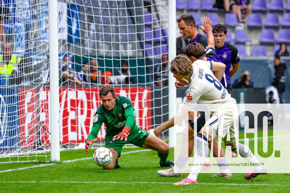 Martin Maennel (FC Erzgebirge Aue), 01, saves a shot by Patrick Wimmer (TSG 1899 Hoffenheim), 08, FC Erzgebirge Aue vs. TSG Hoffenheim, Soccer, DFB Cup, 1st Round, 2026–2027 Season, August 22, 2026, DFL regulations prohibit any use of photographs as image sequences and or quasi-video, FC Erzgebirge Aue vs. TSG Hoffenheim, soccer, DFB Cup, Round 1, 2026–2027 Season, August 22, 2026, Aue