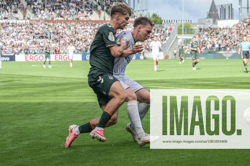 Mick Schmetgen of SV Werder Bremen, age 33, in a tackle; Lüneburger SK vs. Hansa SV Werder Bremen; soccer; DFB Cup; DFB; August 22, 2026. DFB regulations prohibit any use of photographs as image sequences and or quasi-video. Hamburg, Hamburg, Germany