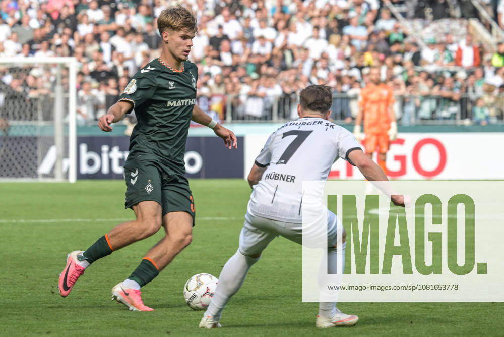 Mick Schmetgen of SV Werder Bremen, age 33, in a tackle; Lueneburger SK vs. Hansa SV Werder Bremen; soccer; DFB Cup; DFB; August 22, 2026. DFB regulations prohibit any use of photographs as image sequences and or quasi-video. Hamburg, Hamburg, Germany