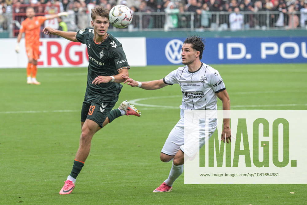 Mick Schmetgen of SV Werder Bremen, age 33, in a tackle; Lüneburger SK vs. Hansa SV Werder Bremen; soccer; DFB Cup; DFB; August 22, 2026. DFB regulations prohibit any use of photographs as image sequences and or quasi-video. Hamburg, Hamburg, Germany