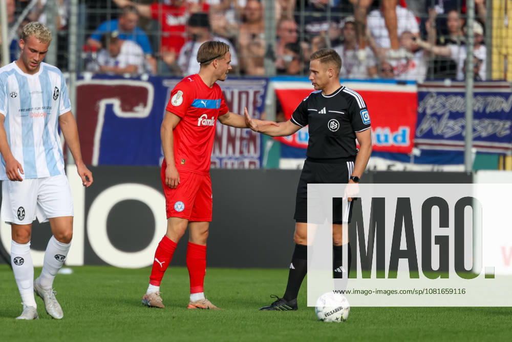 Fould of Jonas Therkelsen (Holstein Kiel), No. 10, is cautioned by referee Felix Weller, GER, TSV 1860 Munich vs. Holstein Kiel, Soccer, DFB Cup, 1st Round, 2026–2027 Season, August 22, 2026, DFL regulations prohibit any use of photographs as image sequences, GER, TSV 1860 Munich vs. Holstein Kiel, Soccer, DFB Cup, Round 1, 2026–2027 Season, August 22, 2026, Munich