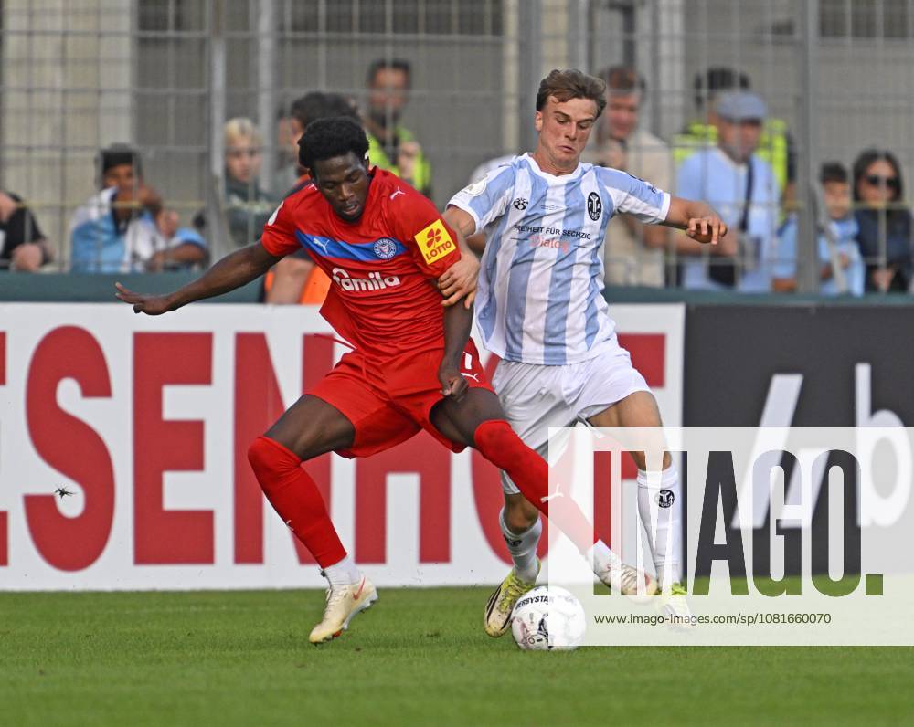 2026–27 DFB Cup, First Round, TSV 1860 Munich vs. Holstein Kiel, at the Stadion an der Grünwalderstrasse in Munich; from left: Faride Alidou (Holstein Kiel) vs. Julian Bell (TSV 1860 Munich)