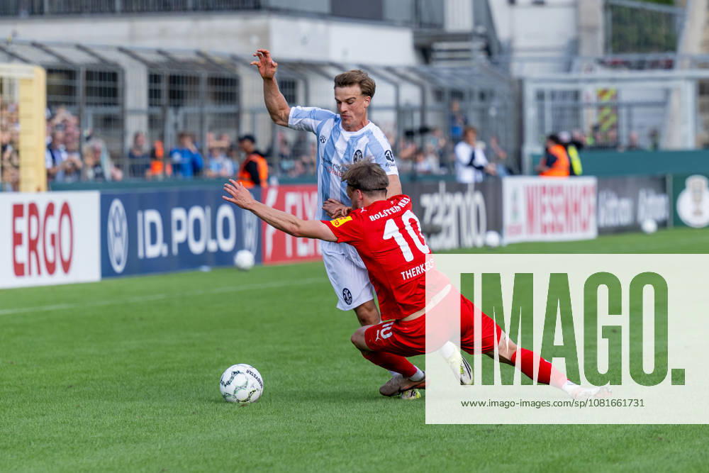 Battle for the Ball: Tackle between Julian Bell (TSV 1860 Munich, No. 02) and Jonas Therkelsen (Holstein Kiel, No. 10), GER, TSV 1860 Munich vs. Holstein Kiel, Soccer, DFB Cup, 1st Round, 2026–2027 Season, August 22, 2026 DFL and DFB regulations prohibit any use of photographs as image sequences and or quasi-video. Photo: HMB Media, Heike Feiner