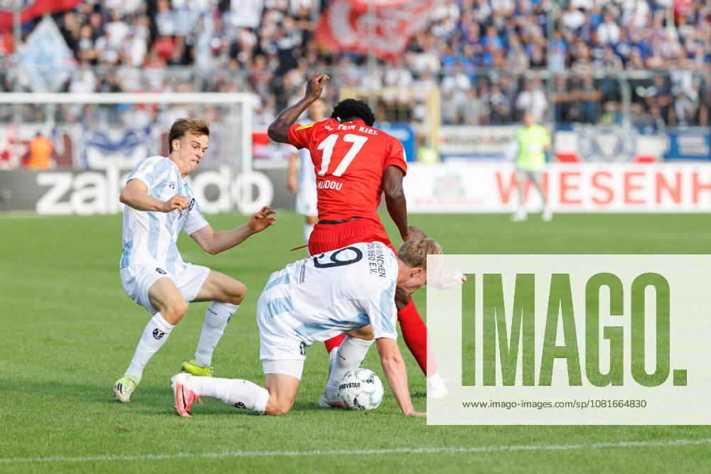 Fabio Wagner, 9, TSV 1860 Munich, and Faride Alidou, 17, Holstein Kiel, during the match between TSV 1860 Munich and Holstein Kiel, soccer, men s, DFB Cup, 2026–2027, First Round on August 22, 2026, in Munich, Municipal Stadium on Grünwalder Straße, Bavaria, Germany