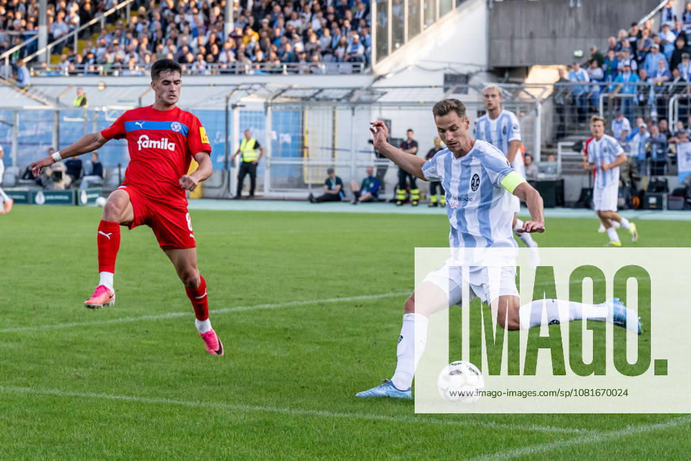 Dennis Dressel, TSV 1860 Munich, 14, clears the ball in his own penalty area ahead of Guillermo Balzi of Holstein Kiel, 08 GER, TSV 1860 Munich vs. Holstein Kiel, Soccer, DFB Cup, 1st Round, 2026–2027 Season, August 22, 2026 DFL and DFB regulations prohibit any use of photographs as image sequences and or quasi-video. Photo: HMB Media, Heike Feiner