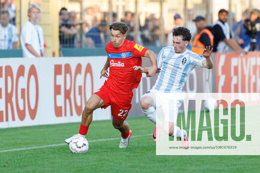 Moritz Reimers, 22, Holstein Kiel, and Lance Fiedler, 47, TSV 1860 Munich, during the match between TSV 1860 Munich and Holstein Kiel, soccer, men s, DFB Cup, 2026–2027, Round 1 on August 22, 2026, in Munich, Städtisches Stadion an der Grünwalder Straße, Bavaria, Germany