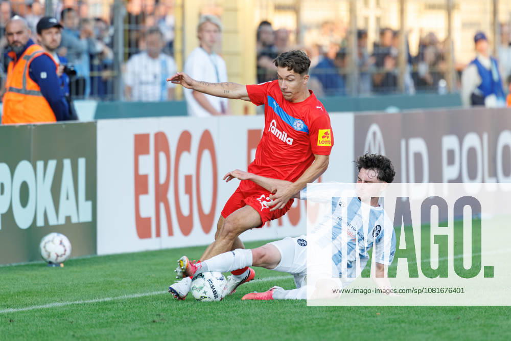 Moritz Reimers, 22, Holstein Kiel, and Lance Fiedler, 47, TSV 1860 Munich, during the match between TSV 1860 Munich and Holstein Kiel, soccer, men s, DFB Cup, 2026–2027, Round 1 on August 22, 2026, in Munich, Städtisches Stadion an der Grünwalder Straße, Bavaria, Germany