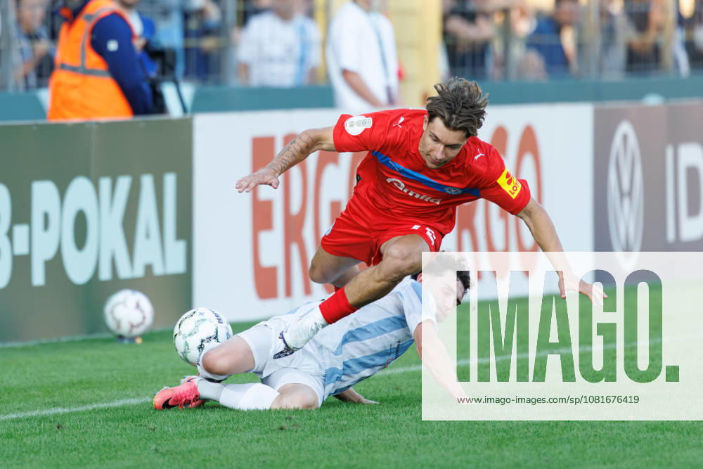 Moritz Reimers, 22, Holstein Kiel, and Lance Fiedler, 47, TSV 1860 Munich, during the match between TSV 1860 Munich and Holstein Kiel, soccer, men s, DFB Cup, 2026–2027, Round 1 on August 22, 2026, in Munich, Städtisches Stadion an der Grünwalder Straße, Bavaria, Germany