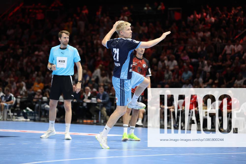 Frederik Bo Andersen, 21, of HSV Hamburg takes a shot, while a referee and a player from MTV Braunschweig can be seen in the background. The Volkswagen Halle in Braunschweig is packed with spectators. Frederik Bo Andersen, 21, of HSV Hamburg takes a shot at the Volkswagen Halle.
