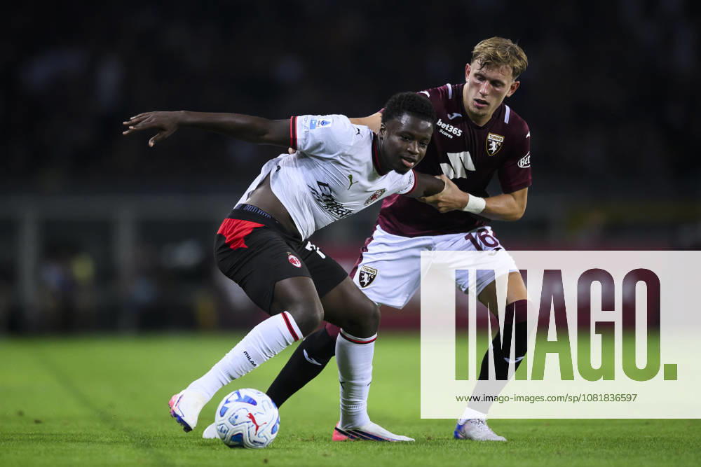 Torino FC v AC Milan - Serie A Alphadjo Cisse of AC Milan competes for the ball with Marcus Pedersen of Torino FC during the Serie A football match between Torino FC and AC Milan. Turin Italy