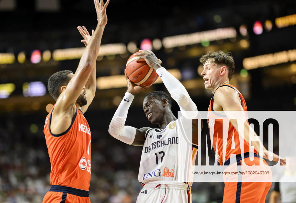 Dennis Schröder of Germany between two players from the Netherlands, in action, Men s Basketball FIBA World Cup Qualifying Game, Second Round Group K, Germany vs. the Netherlands, on August 27, 2026, at the LanxessArena in Cologne, Germany