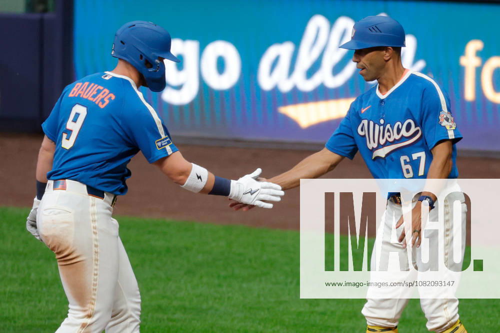 Milwaukee Brewers first baseman JAKE BAUERS (9) high fives Milwaukee Brewers first base coach SPENCER ALLEN (67) in a baseball game, Friday, Aug. 28, 2026, in Milwaukee, Wisconsin. Milwaukee USA - ZUMAa325 20260828_zsa_a325_014