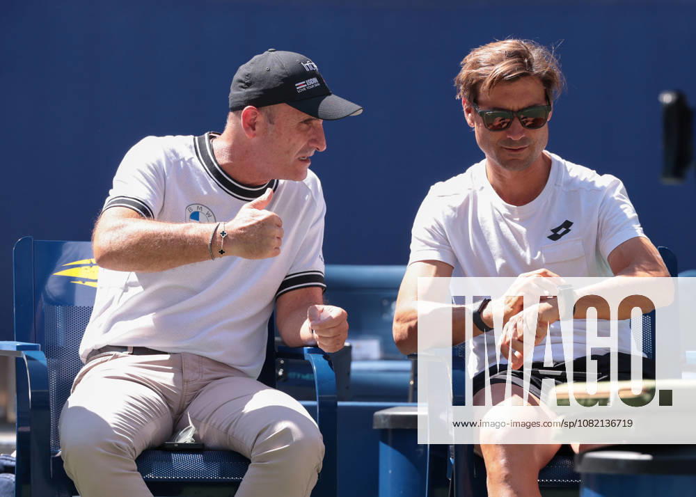 Carlos Alcaraz and his manager, Albert Molina, talking with David Ferrer on the sidelines during practice at the U.S. Open Championships, Billie Jean King National Tennis Center, Flushing Meadows, New York, USA