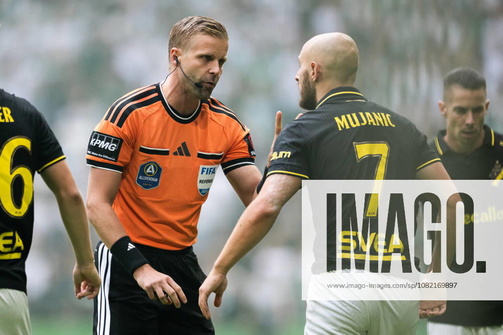 AIK s Amel Mujanic discusses the play with referee Glenn Nyberg during the Allsvenskan soccer match between AIK and Hammarby in Stockholm