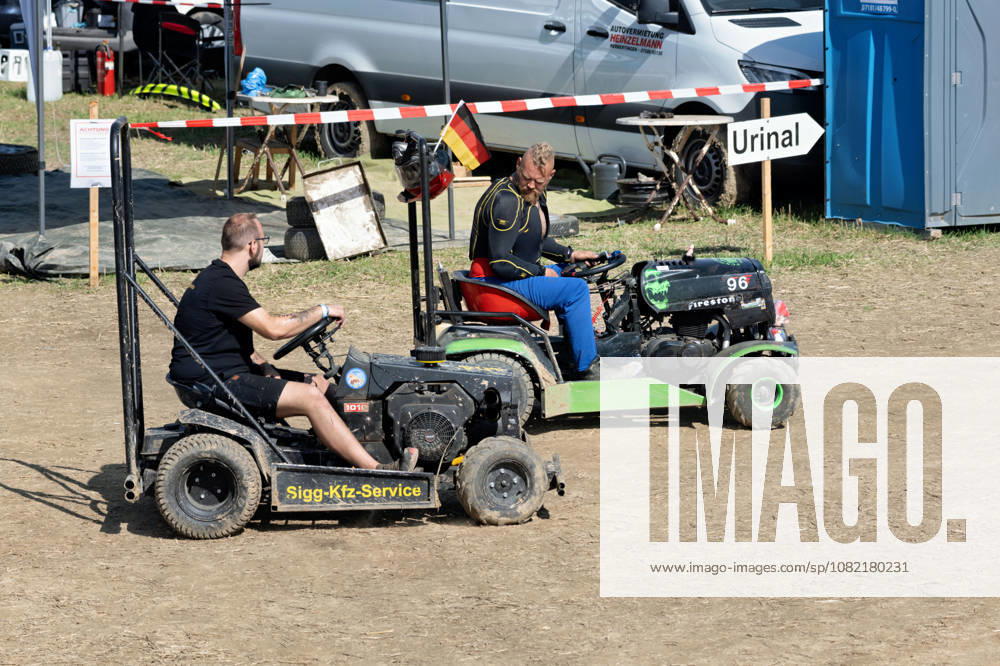 Two drivers with modified lawn tractors in the paddock at the FUN CROSS stock car race near Dietenwengen. The small vehicles have been modified for racing and equipped with roll bars. FUN CROSS stock car race in Eberhardzell. Eberhardzell, Dietenwengen