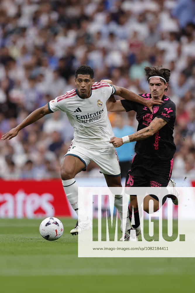 Jude Bellingham of Real Madrid CF and Angel Recio of Málaga CF battle for the ball during the LaLiga EA Sports match between Real Madrid CF and Málaga CF at Estadio Santiago Bernabéu on August 30, 2026, in Madrid, Spain. Photo by Manu Reino, DeFodi Images