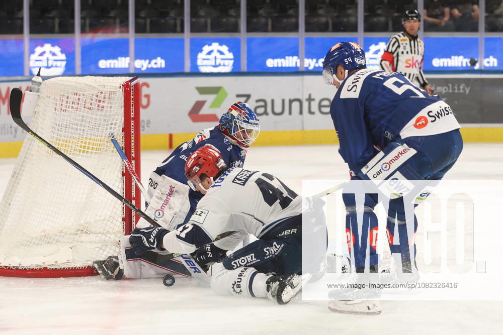 Zurich, SWITZERLAND, Swiss Life Arena, 2026–2027 Ice Hockey Season, Exhibition Game: ZSC Lions vs. Schwenninger Wild Wings, Alexander Karachun (Wild) vs. Christian Marti (ZSC Lions) in front of goaltender Robin Zumbuehl (ZSC Lions)