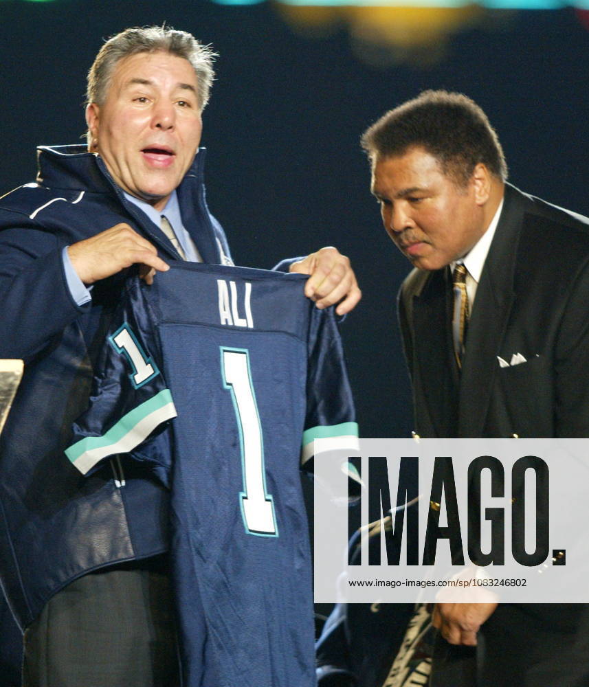 Former Canadian boxing champ George Chuvalo presents Muhammad Ali a Toronto Argonauts jersey at a Parkinson s Disease fundraiser during half time of the Toronto Argonauts vs Ottawa Renegades CFL matchup in Toronto on Sunday Oct. 20, 2002. GEORGE CHUVALO, MUHAMAD ALI - ZUMAc35_ 20021020_zaf_c35_001