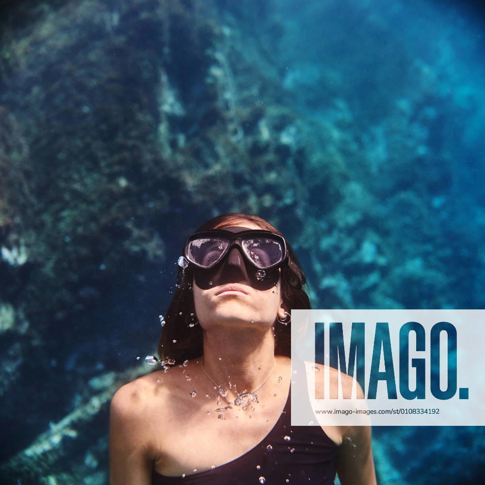 Young female diver in swimsuit and snorkeling mask floating in clean transparent sea water x0x,2020,quadrat Frau,woman,Tauchers,diver,Unterwasser,underwater,Maske,mask,Schutzbrillen,goggles,Schnorchel,snorkel,scuba,Wasser,water,swims,swim,Meer,sea,Ozean,ocean,Jung,young,weiblich,female,reinigen,clean,durchsichtig,transparent,Abtauchen,dive,Urlaub,holiday,Ferialjob,vacation,Abenteuer,adventure,Lebensstil,lifestyle,Entdeckung,discovery,erforschen,explore,Reisen,travel,Natur,nature,Marineeinsatz,marine,schweben,float,Aktivit?t,activity,Tourismus,tourism,Ausr?stung,equipment,aktiv,active,Schwimmerin,swimmer,Freiheit,freedom,Liebhaberei,hobby,Tief,deep,Blase,bubble,Unterseeischer,undersea,Umwelt,environment,saftey,safety,gehende,depth,Leben,life,Unsch?rfe,blur,selective focus,wiederzuerkennen,unrecognizable,premiumd,Highlight,CREATIVE, WELLNESS UND GESUNDHEIT IMAGO Creative Club Med Strand, Aktiv IMAGO Creative Club Med Beach, Active Freizeit Model Released