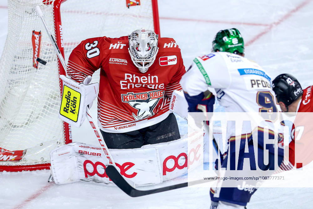 Ice hockey, DEL, Kölner Haie vs. Eisbären Berlin, Matchday 3, 2026–27 season, Lanxess Arena, Cologne; Leo Pföderl of Eisbären Berlin (No. 93) shoots on goalie Janne Juvonen of the Kölner Haie (No. 30); North Rhine-Westphalia, Germany