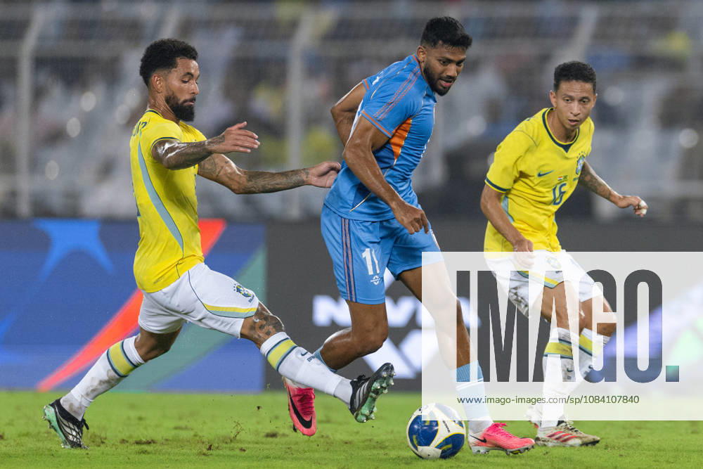 Douglas Luiz Soares de Paulo of Brazil and Rahim Ali of India duel for the ball during friendly match between India and Brazil at the Vivekananda Yuba Bharati Krirangan (VYBK) Stadium in Kolkata, India on 3rd October, 2026