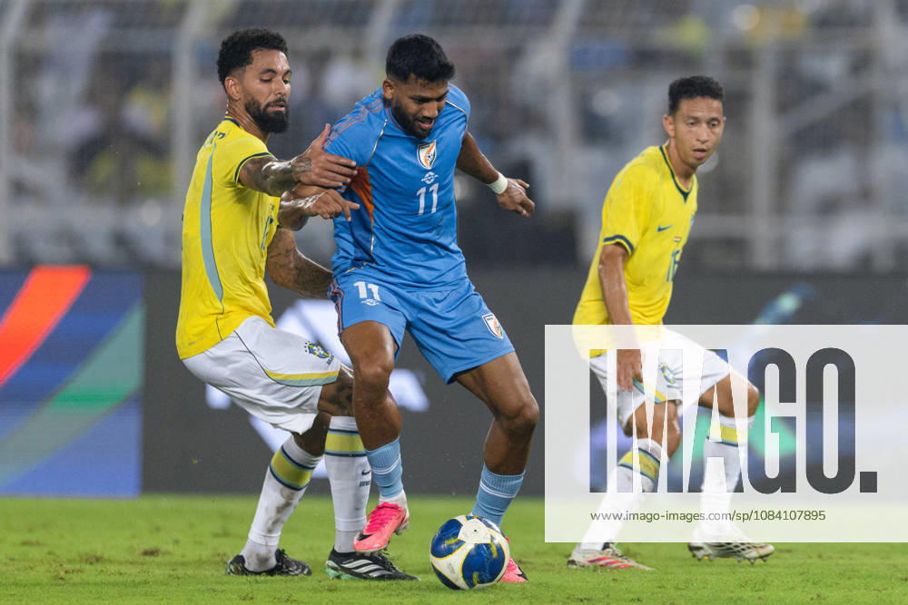 Douglas Luiz Soares de Paulo of Brazil and Rahim Ali of India duel for the ball during friendly match between India and Brazil at the Vivekananda Yuba Bharati Krirangan (VYBK) Stadium in Kolkata, India on 3rd October, 2026