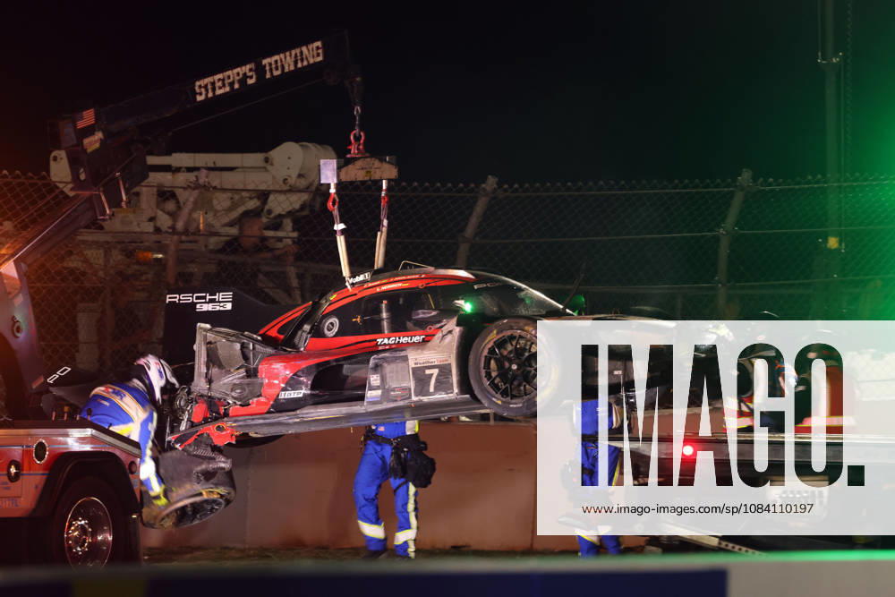 The Porsche 963 No. 7, severely damaged in an accident, with Felipe Nasr, Laurin Heinrich, and Julien Andlauer at the tow hook, IMSA racing series, 29th Motul Petit Le Mans race, Road Atlanta, Georgia, USA, October 3, 2026, Accident, Retirement, Porsche Penske Motorsport
