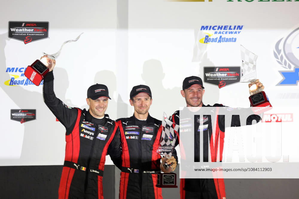 Laurens Vanthoor (BEL), Matt Campbell (AUS), Kevin Estre (FRA) in the No. 6 Porsche 963 on the podium with trophies, awards ceremony, IMSA racing series, 29th Motul Petit Le Mans race, Road Atlanta, Georgia, USA, October 3, 2026, 10-hour race